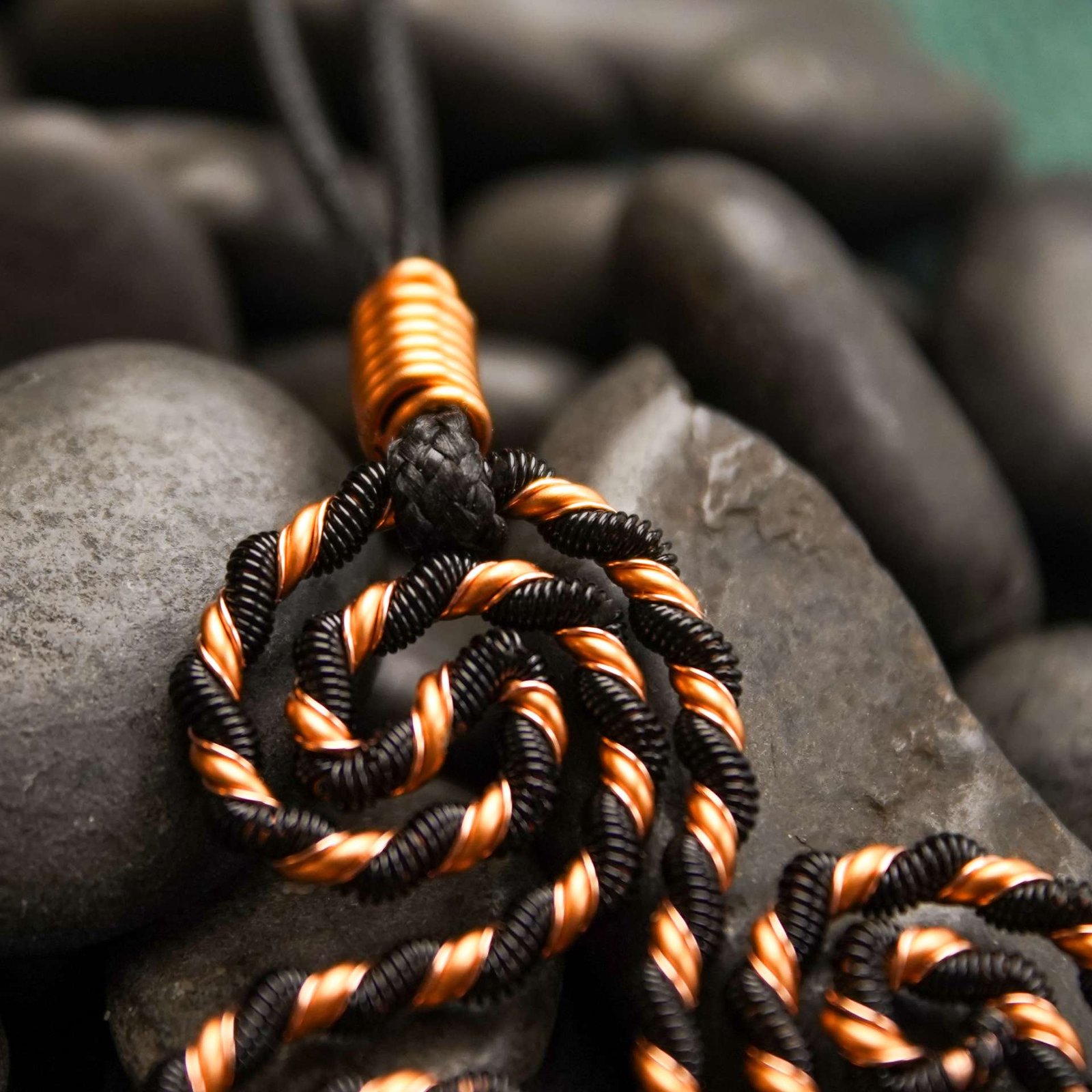 Close-up of black spiral copper coil showing sacred geometry pattern and resonance details