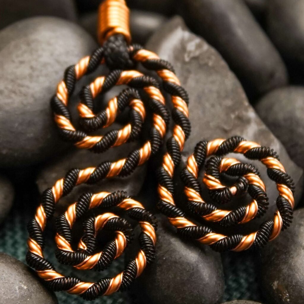 Copper triskelion energy necklace with black enamel finish for EMF shielding and calm