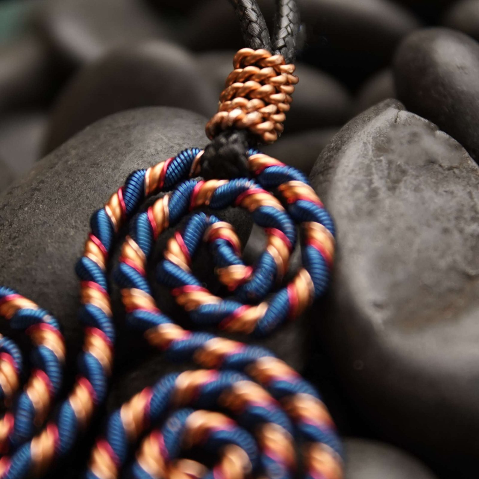 Close-up of triskelion coil showing copper twist and resonant geometry for aura balance and EMF protection